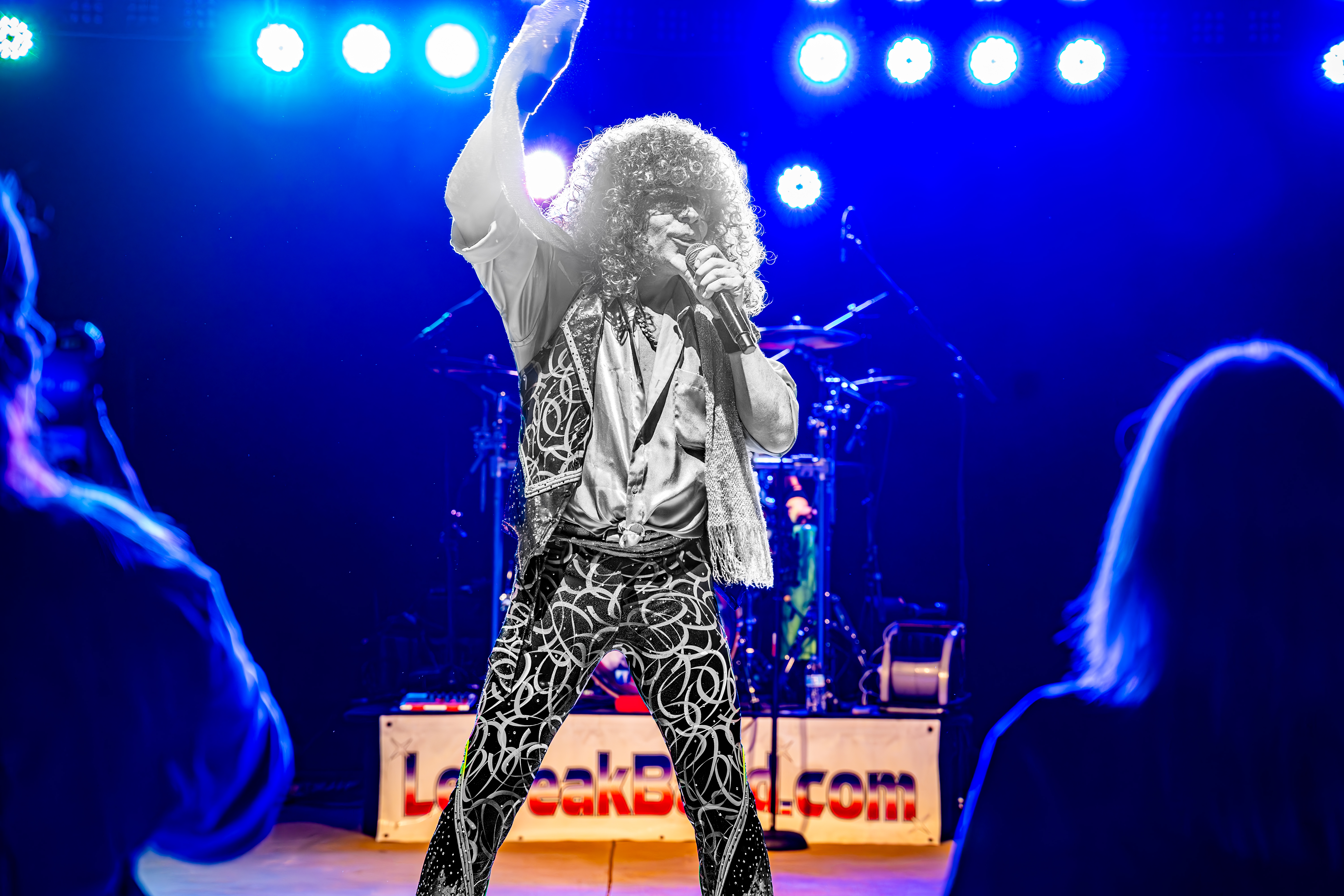 Le Freak performing at the Big Easy in Little Elm with bright colorful lights shining on him