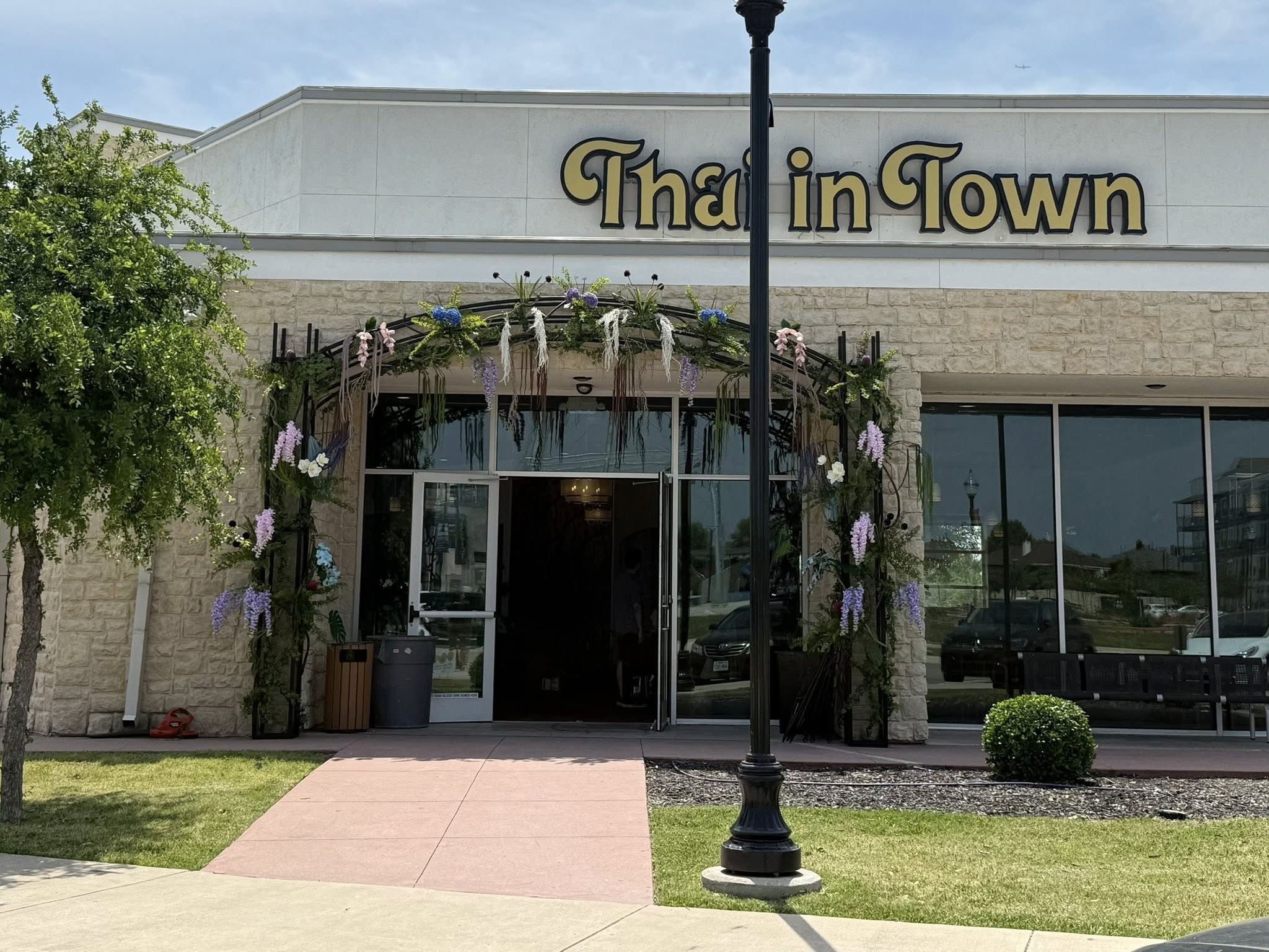 Building that is tan and says Thai in Town